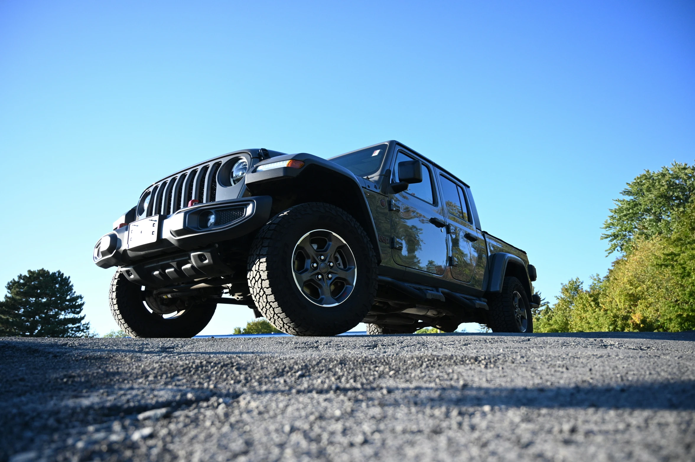 a jeep truck parked on the side of a road