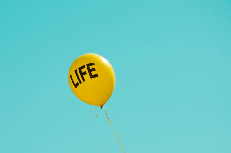 a yellow balloon is shown with the word life written on it