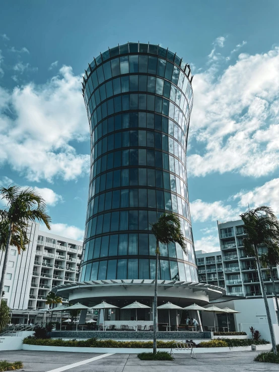 a large glass building near a couple of buildings