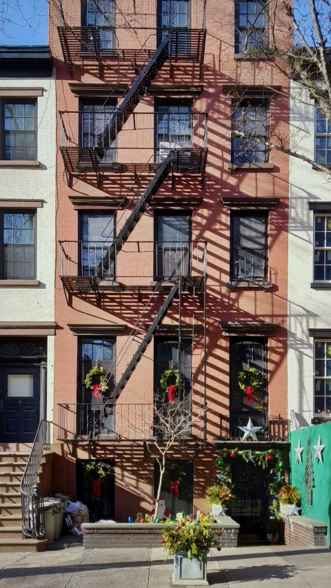 a fire escapes between two brick buildings on a sunny day