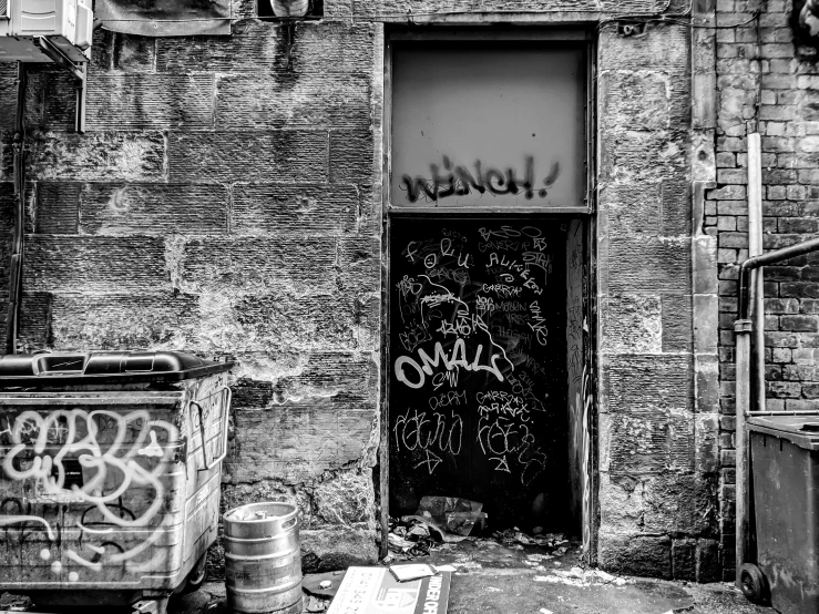 a door and garbage bin are shown near a brick wall