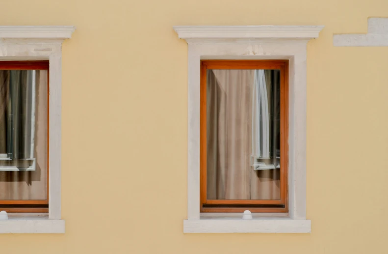 two windows showing a building with a tall brown brick window