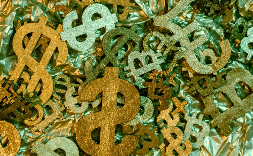 golden dollar signs that are scattered around each other