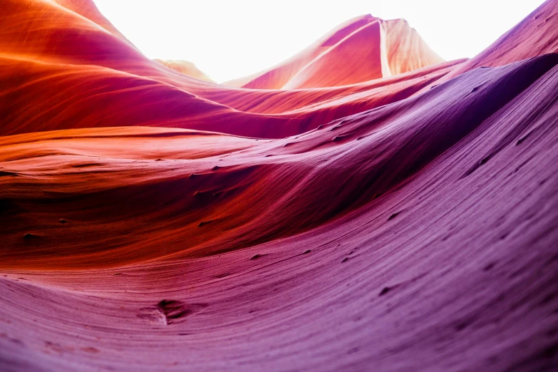 a white blue pink and yellow po with sand dunes