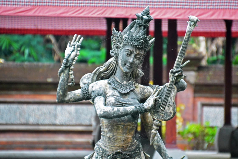 a statue with two swords in its hands