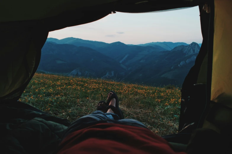 view from inside a tent overlooking a scenic mountain valley