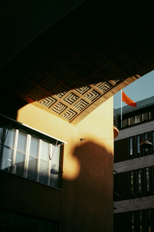 the shadow of a building on a side wall