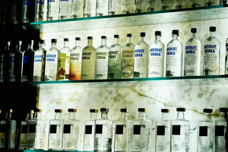 a variety of bottles of alcohol sitting on shelves