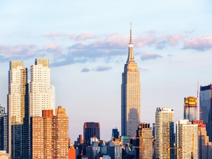 the sky is partly blue in the city as the skyscrs rise