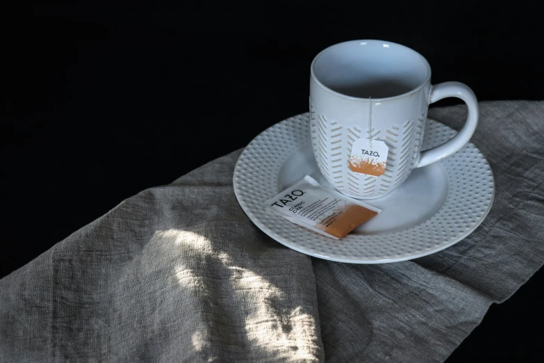 a cup that is sitting on a white saucer