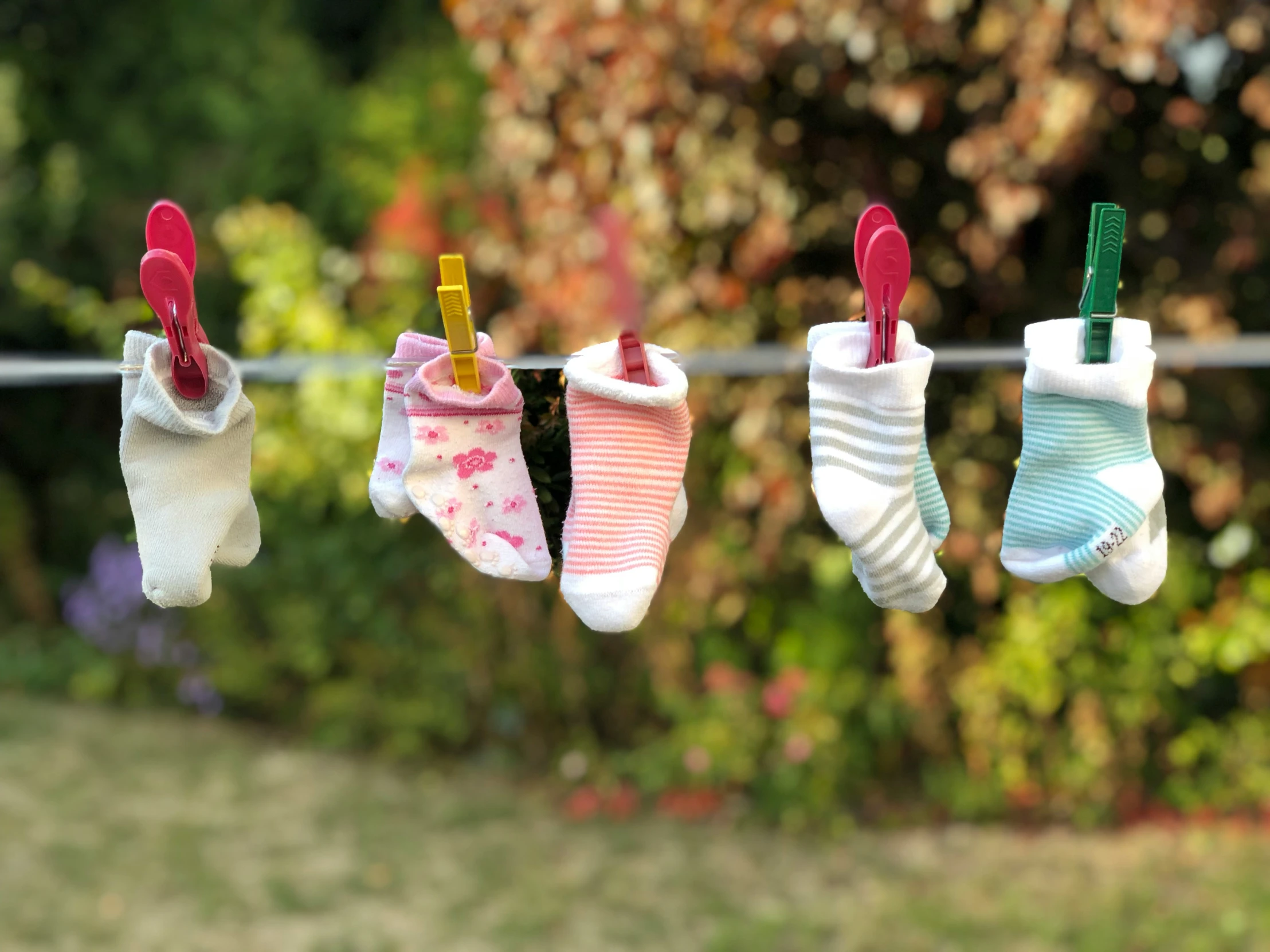 little socks hanging from a clothes line