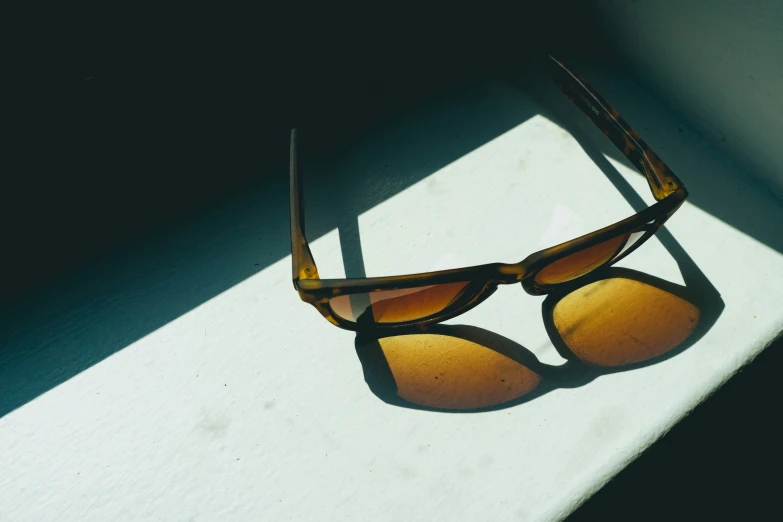 the reflection of a pair of sunglasses on the white surface