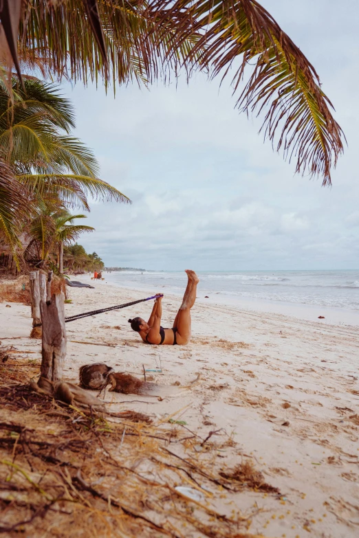 a person on the beach that has a hammock in his hand