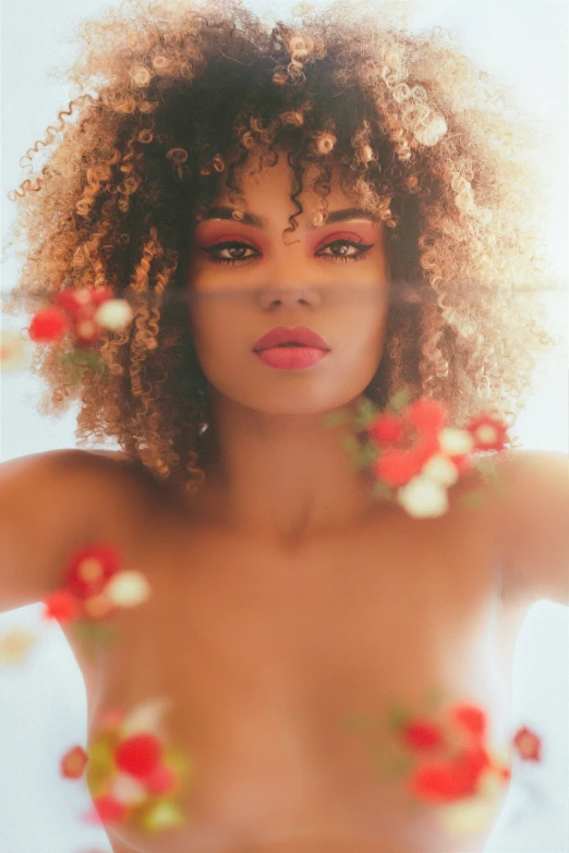 a woman with an afro and flowers on her body