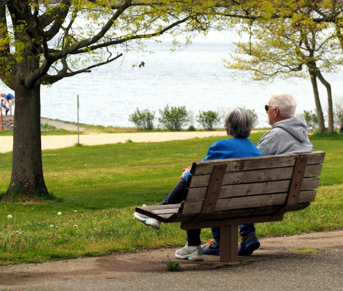 a man and a woman are sitting on a bench