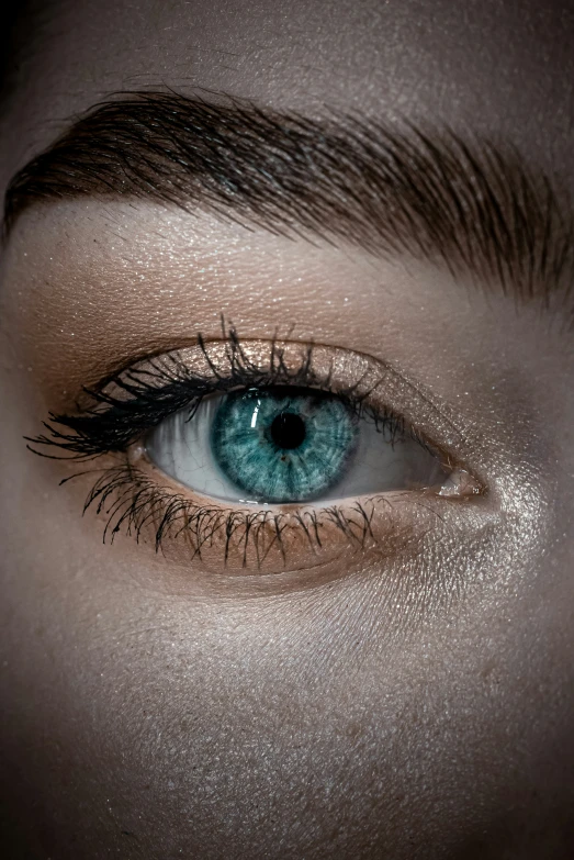 a woman's blue eye with long lashes