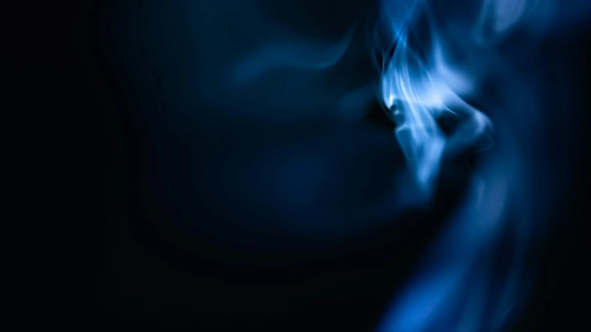 some blue smoke is burning in the dark