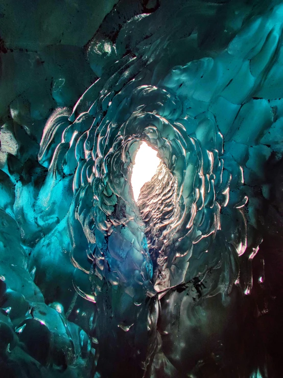 a ice cave with a sun peeking out