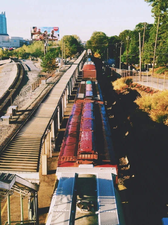 train on tracks passing over an overpass and a building