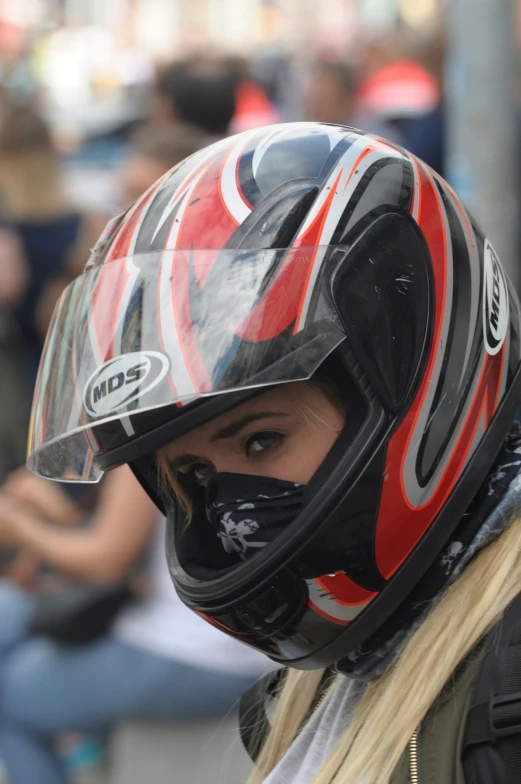 young woman with a full face motorcycle helmet and protective gear