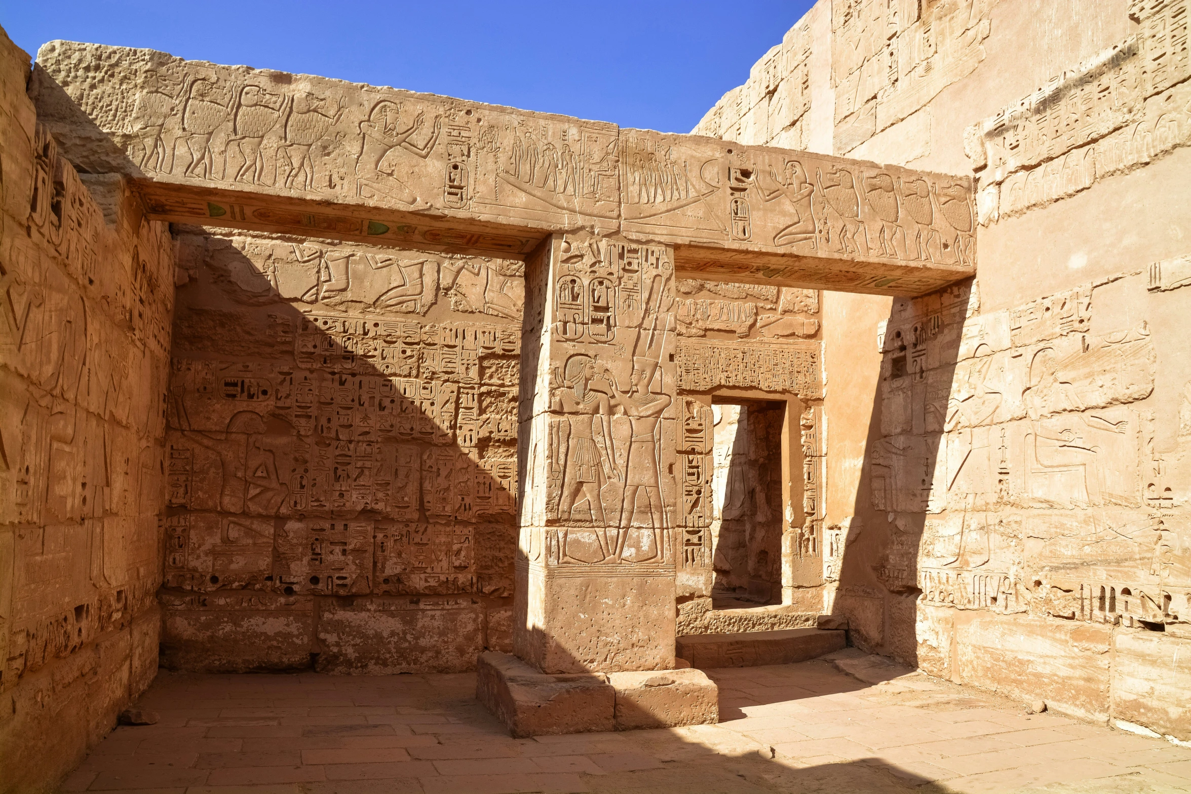 ancient architectural stone work with small doorways on the sides