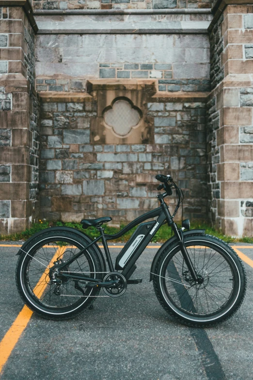 there is a black bicycle parked in a parking lot