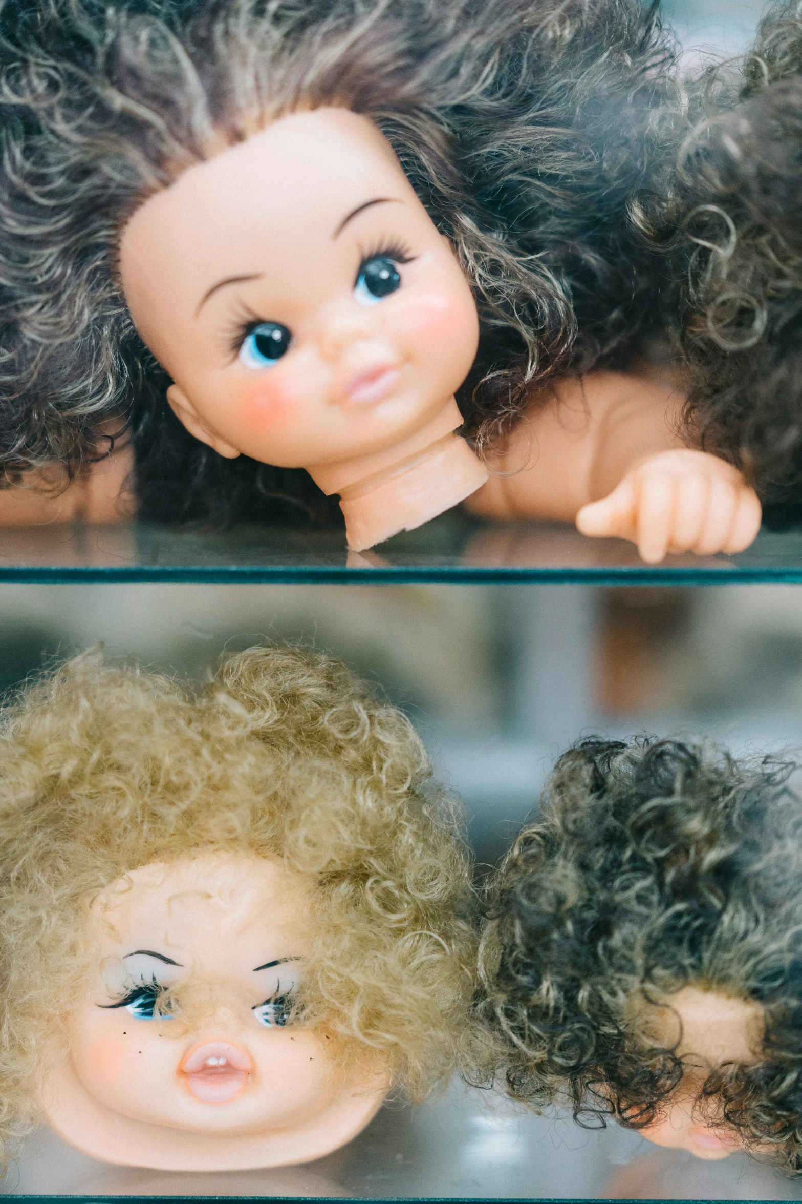 two dolls with hair looking out the window