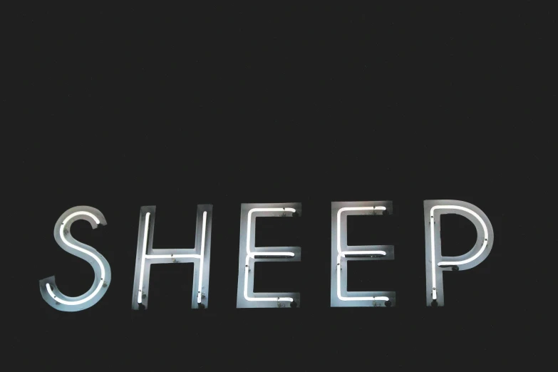 an abstract typography of sheep in white text on a black background