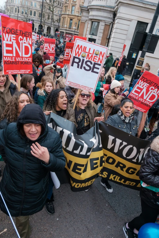 a bunch of people holding up signs in the street