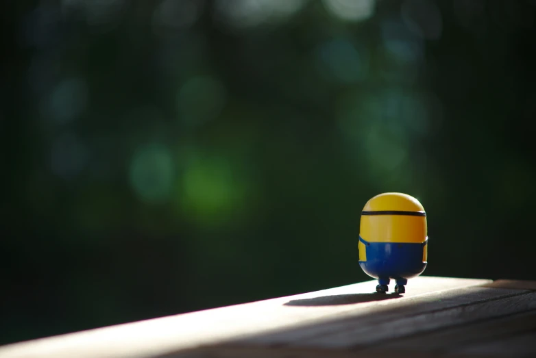 a toy figurine sitting on top of a wooden board