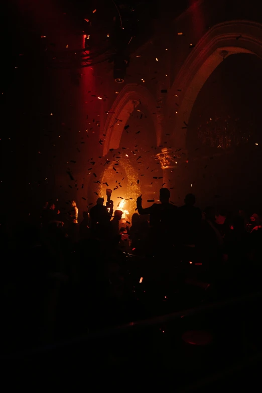 a group of people standing around a lit up stage