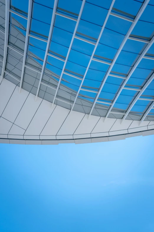 the side of a large plane flying through a blue sky