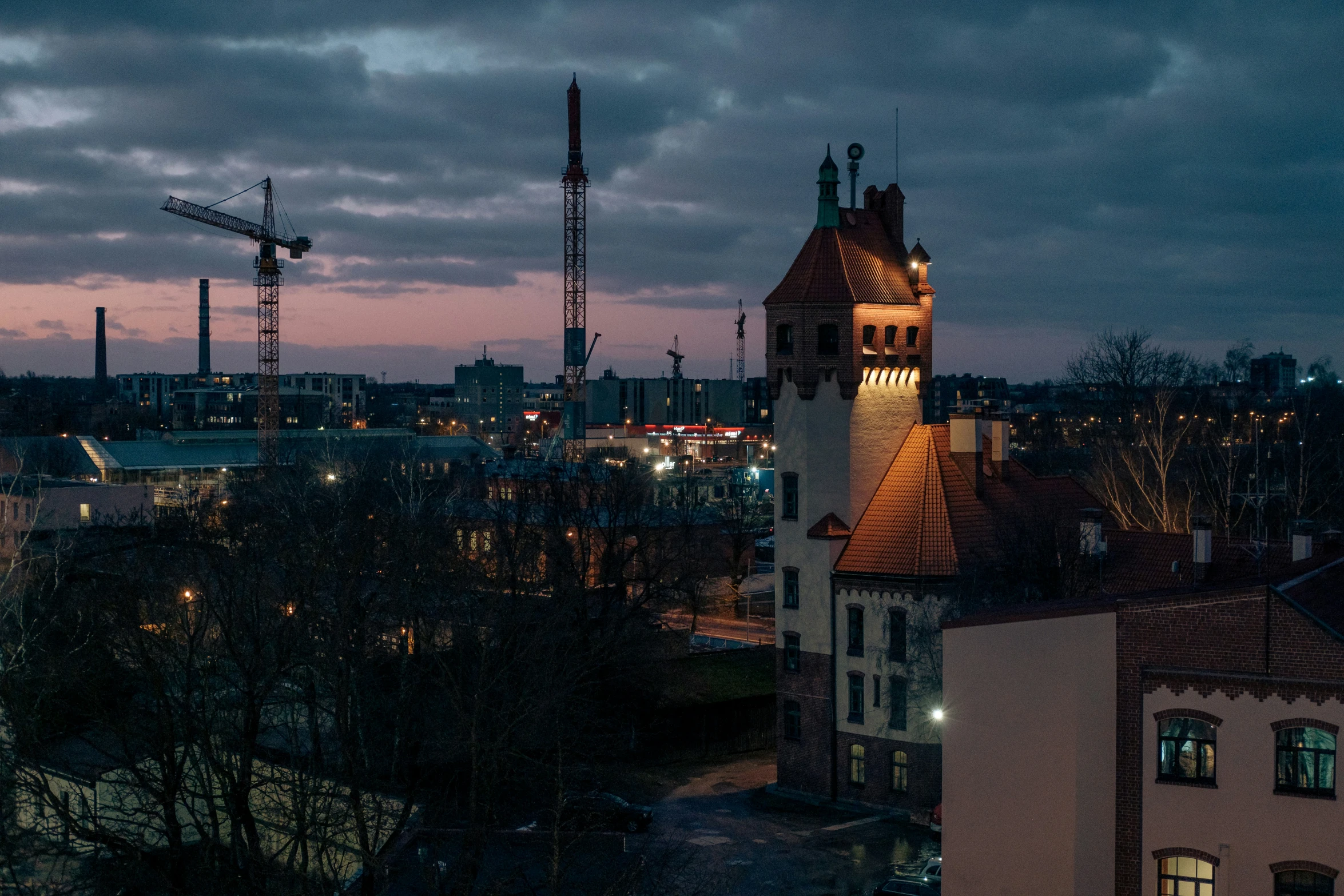 a view of an old city with tall buildings in the distance