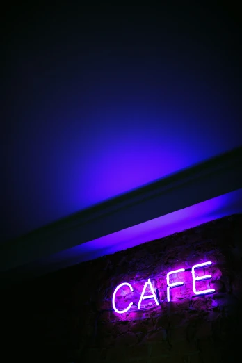the sign reads cafe against the dark background