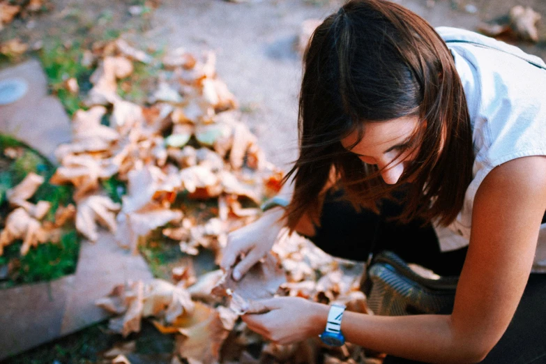 a woman kneeling down while  soing on the ground