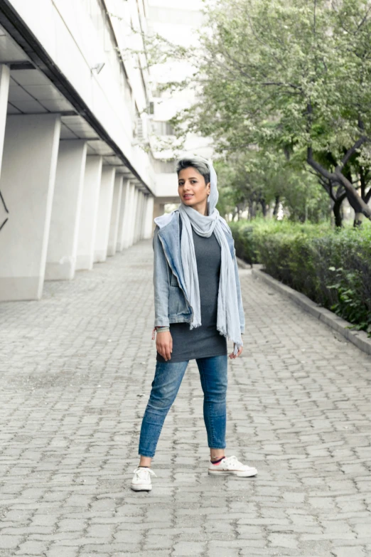 the young woman is posing on the street