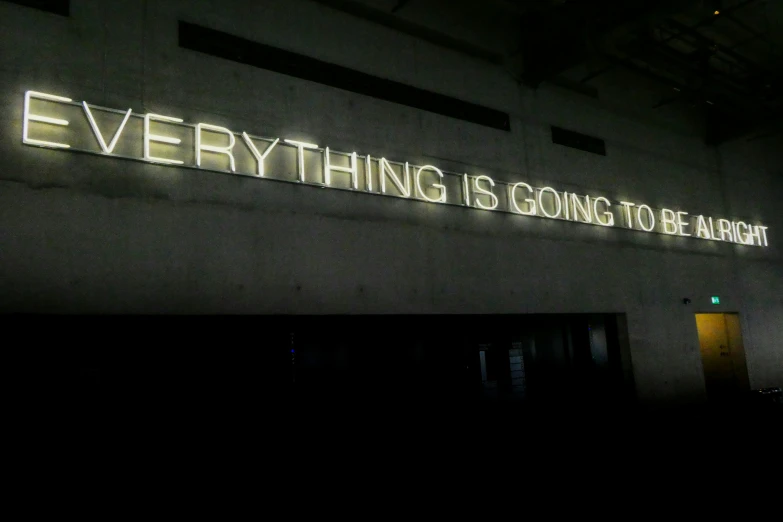 lit sign of everything is going to be alright on an illuminated wall