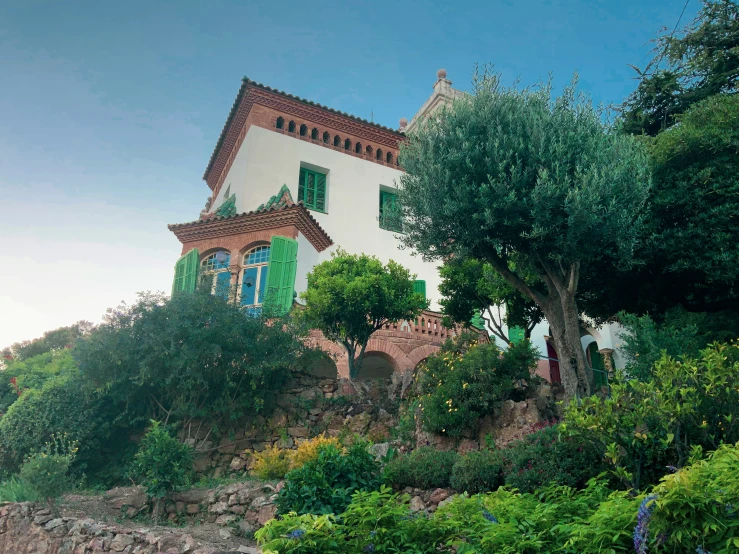 an old style house painted white with green trim