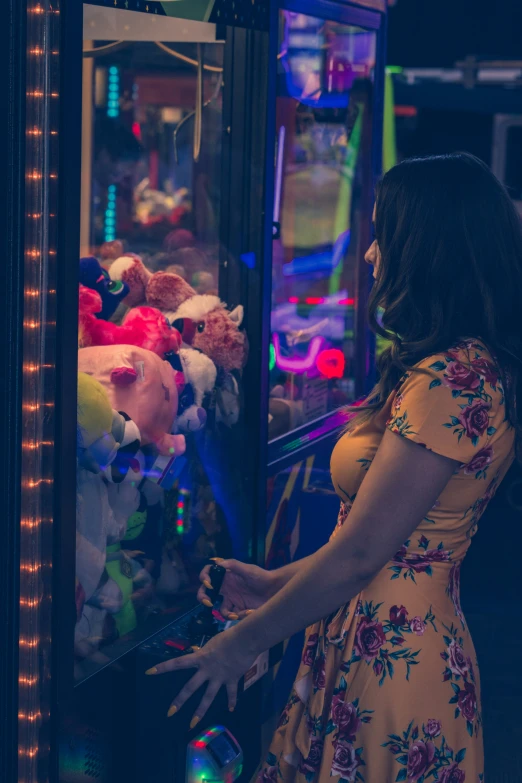 a woman in a dress standing by an ice cream vending machine