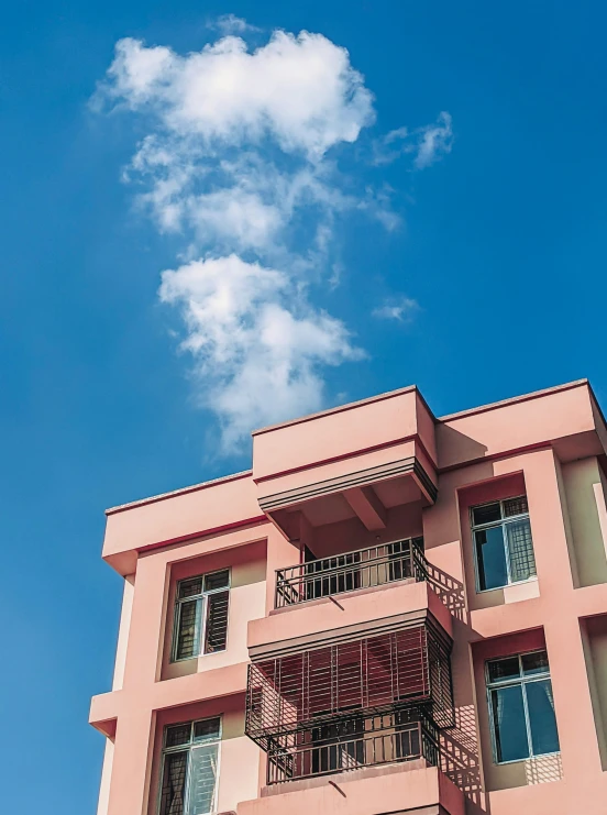 an apartment building with balconyes against the blue sky