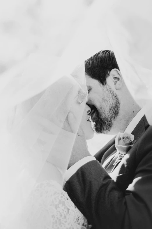 the groom is taking a picture while holding the bride's hair