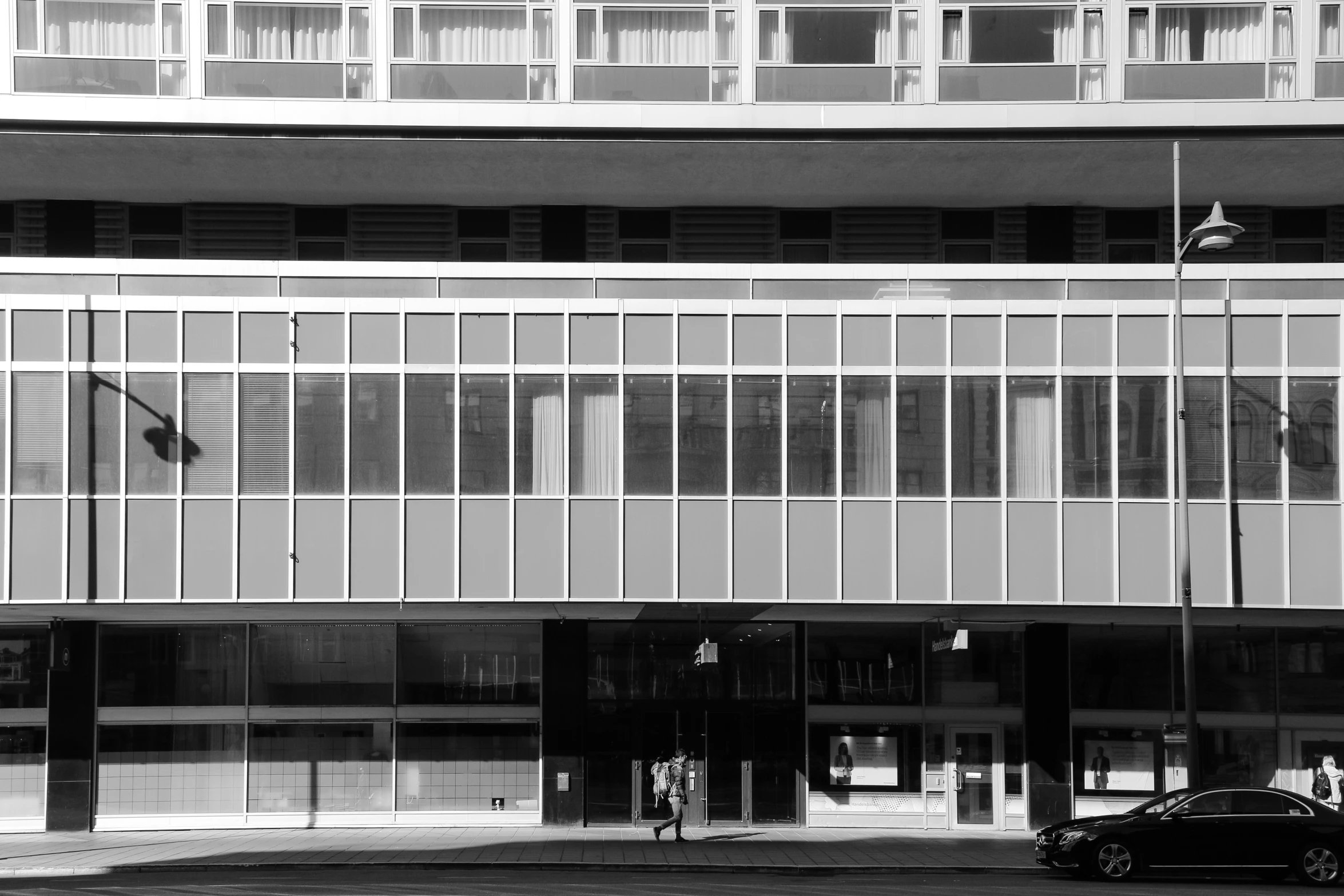 an open building next to a street with a car