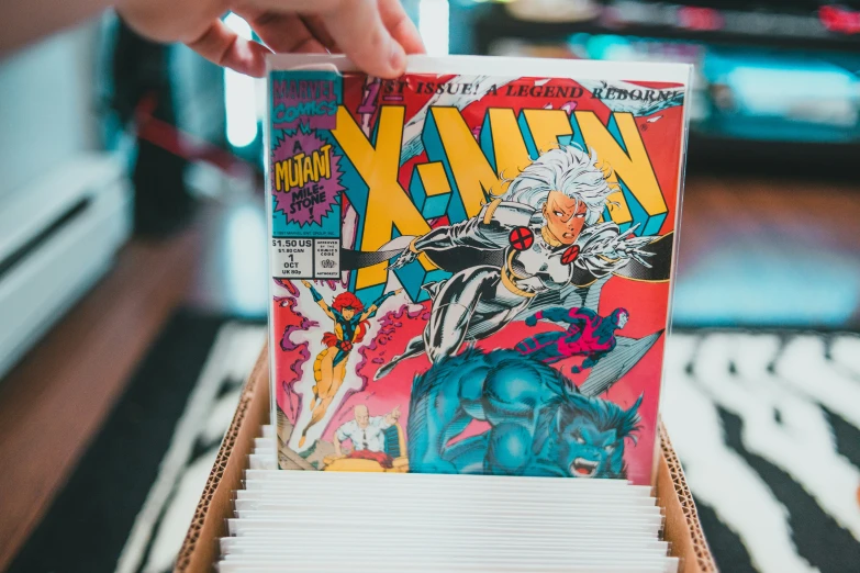 a person opening a comic book with their hand