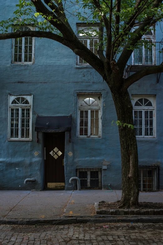 an apartment building with two balconies is painted blue