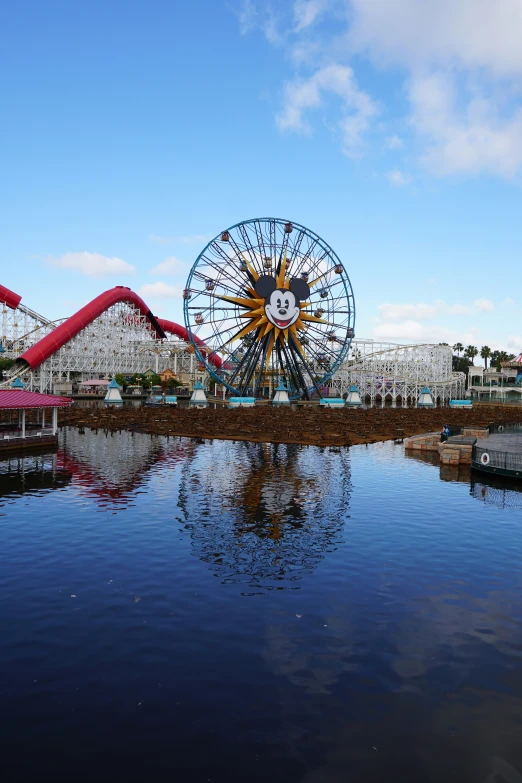 the carnival is reflected in the still water of the lake