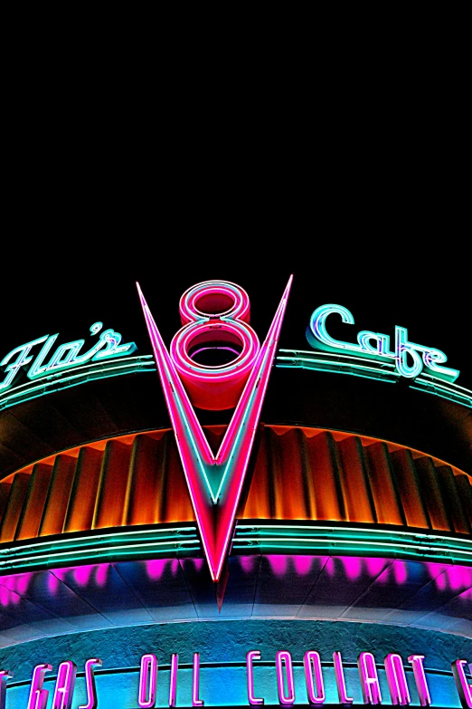 an illuminated theater at night with neon lights