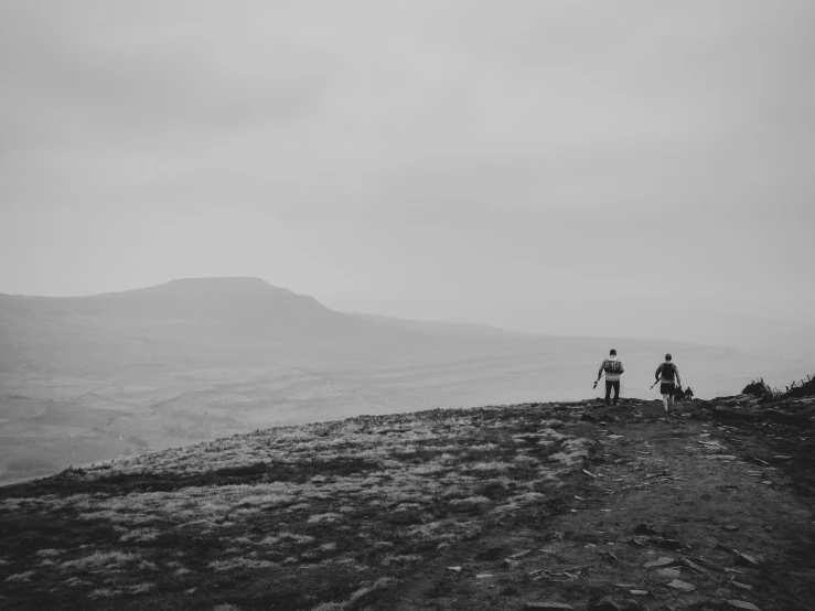 two people on a hill overlooking the view