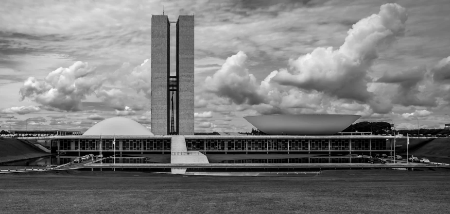 a large building sits beneath a cloudy sky