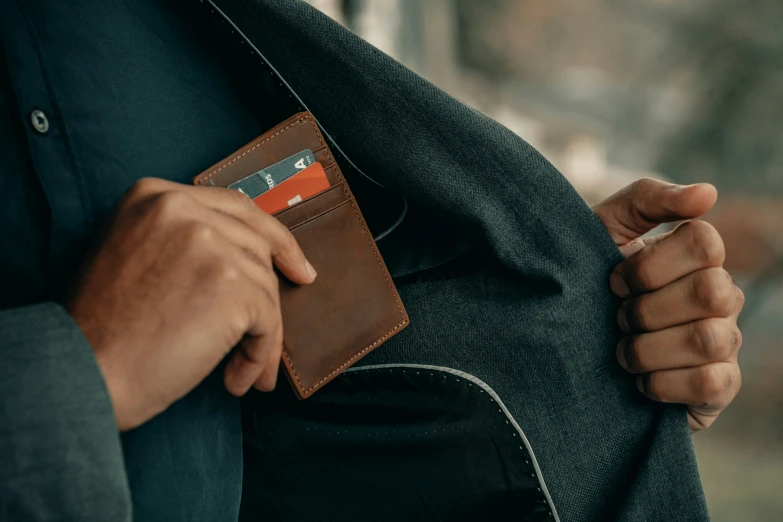 the man has a leather card case on his lapel