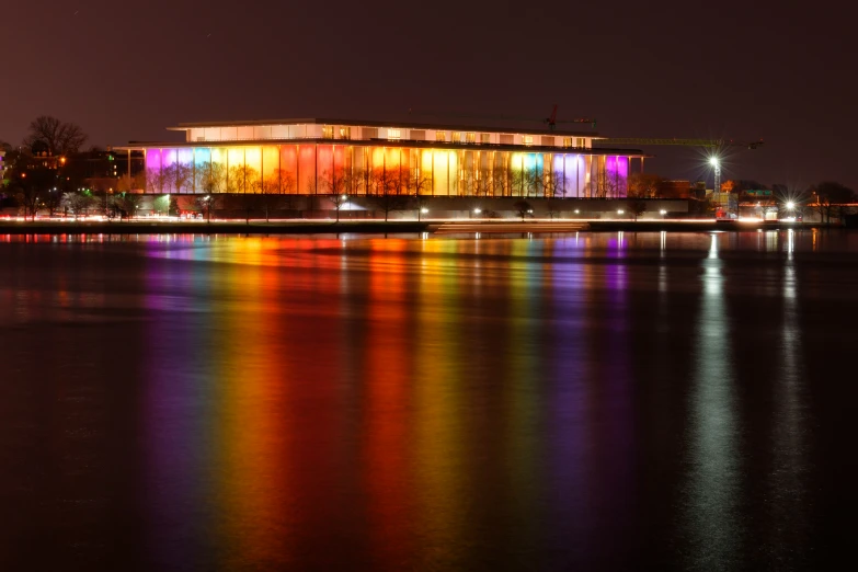 buildings and lights reflecting in the water at night